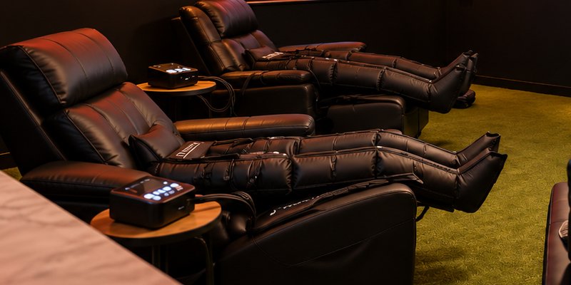Compression boots fitted on reclining chairs at Baseline Recovery